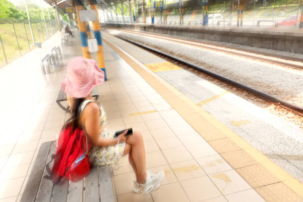 Asian woman at train station in Kuala Lumpur, Malaysia