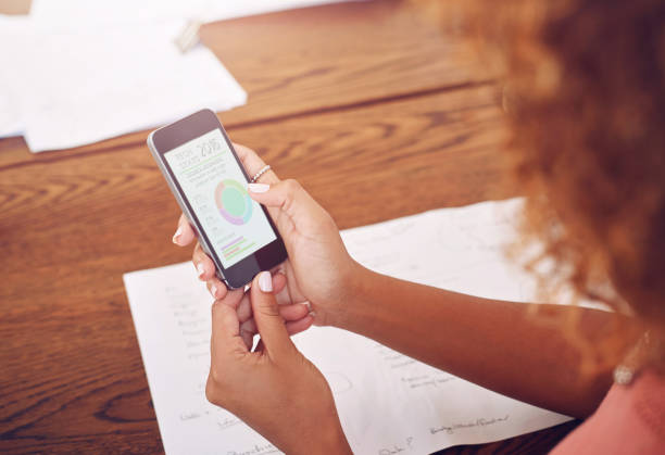 istock Phone, hands or designer with chart for research, technology or graphs analysis on website. Reading data analytics, planning or female person working stats update on mobile app screen with paperwork 2156704416