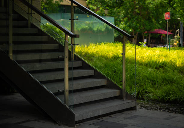 The staircase outside the building is next to the plant