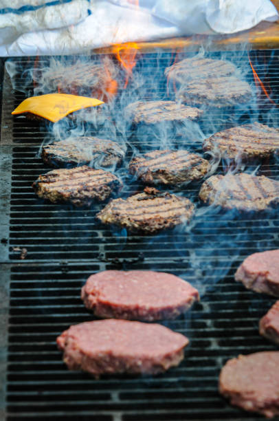 istock Adding Cheese to Cooking Burgers 2156714332