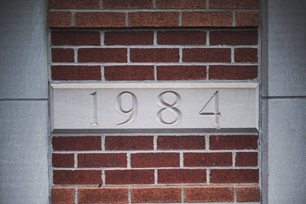 istock Stone plaque with 1984 engraving in brick wall 2156717506