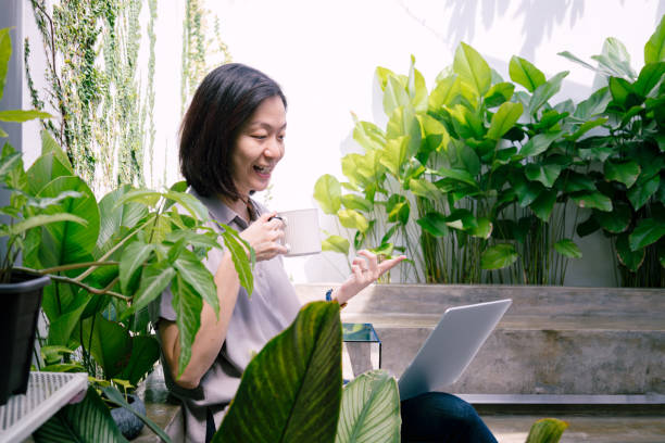 istock Asian Woman Working From Home Backyard Using Laptop 2156718300