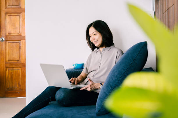 istock Asian Woman Working From Home Using Laptop 2156718791