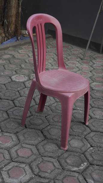 istock Red plastic chairs are placed in the garden 2156719701