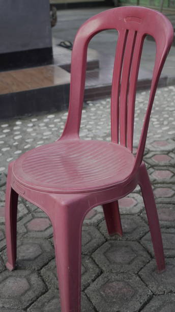 istock Red plastic chairs are placed in the garden 2156719706