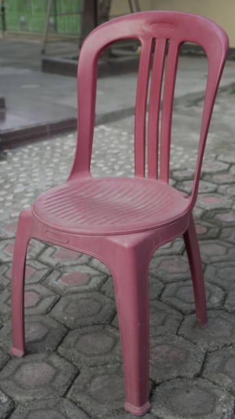 istock Red plastic chairs are placed in the garden 2156719707