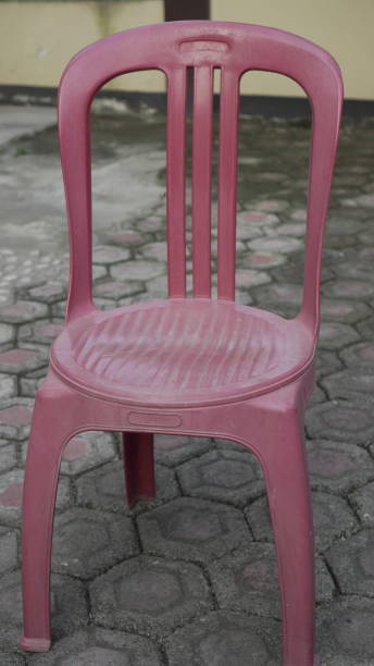istock Red plastic chairs are placed in the garden 2156719716