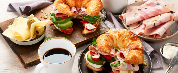 istock Croissant with ham and cheese on board and plate. Breakfast concept. 2156723090