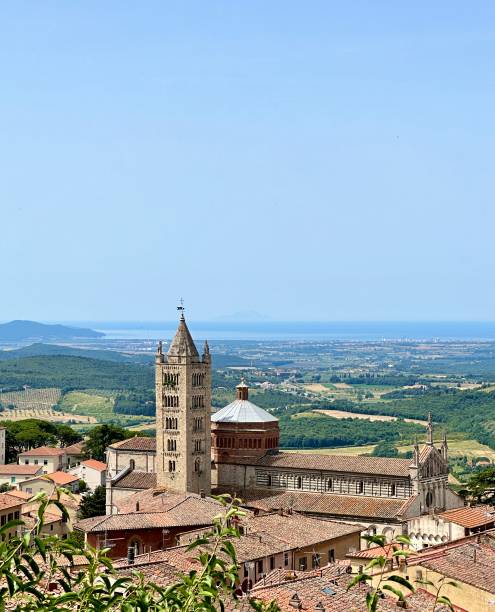 The photo was taken on a beautiful springtime day in Massa Marittima (Tuscany, Grosseto, Italy) and shows a top view of the Saint Cerbone’s cathedral and of the surrounding environment, up to the sea.