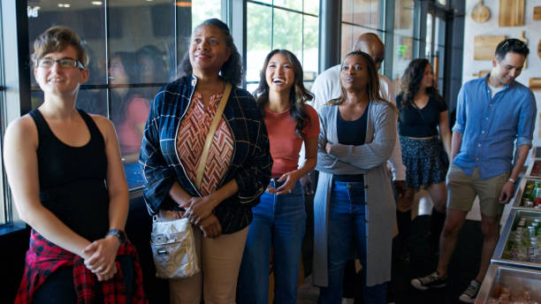 istock Diverse Group of Customers in a Queue Waiting to Order in a BBQ Restaurant 2156725565