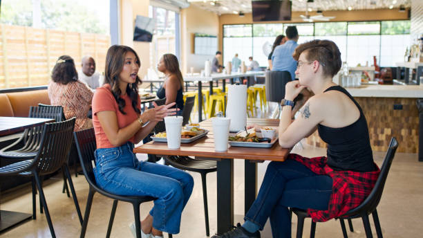 istock Two Friends Chatting inside a BBQ Restaurant in Houston, Texas 2156725581