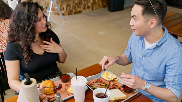 istock Two Young Friends Chatting during Lunch in a BBQ Restaurant 2156725595