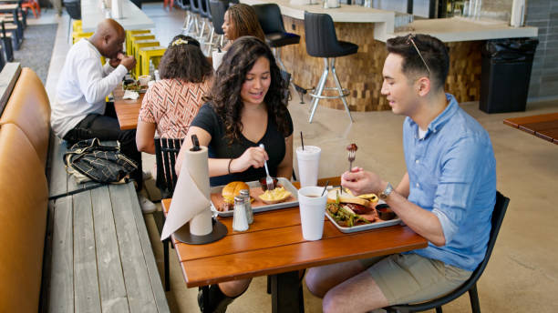 Two Friends Sitting at a Table in a BBQ Restaurant