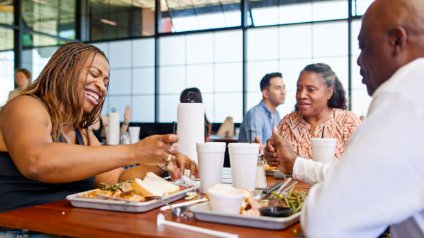 istock Three Friends Eating Food inside BBQ Restaurant 2156725611