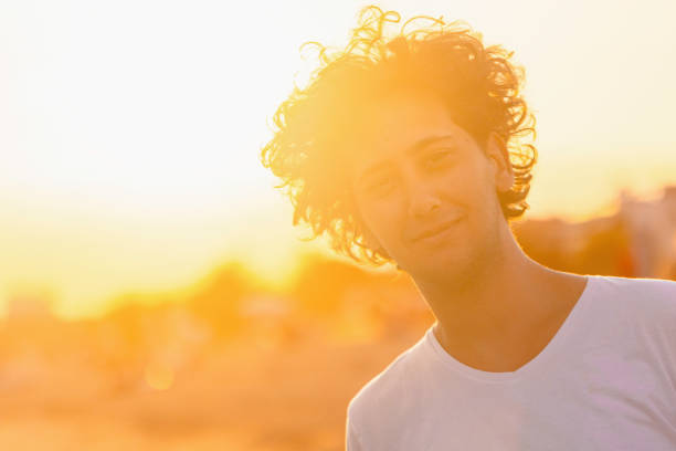 istock Young Caucasian man, on the beach during majestic sunset 2156725898