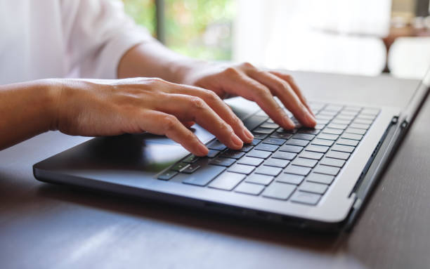 istock Closeup image of a woman hands working and typing on laptop computer keyboard 2156727330
