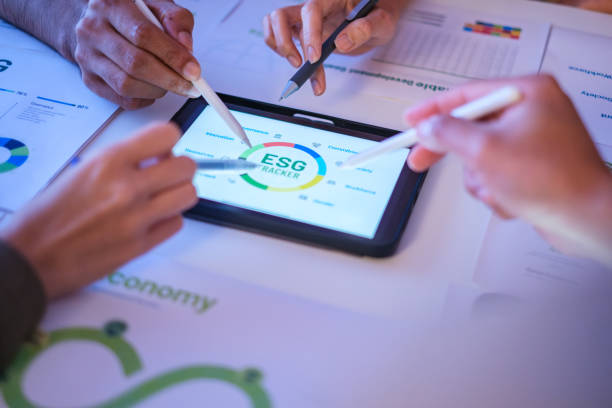 istock close up diversity team brainstorming focused on ESG (environment,social,governance)  with tablet or sdgs goals in a sustainable green office at night 2156728051