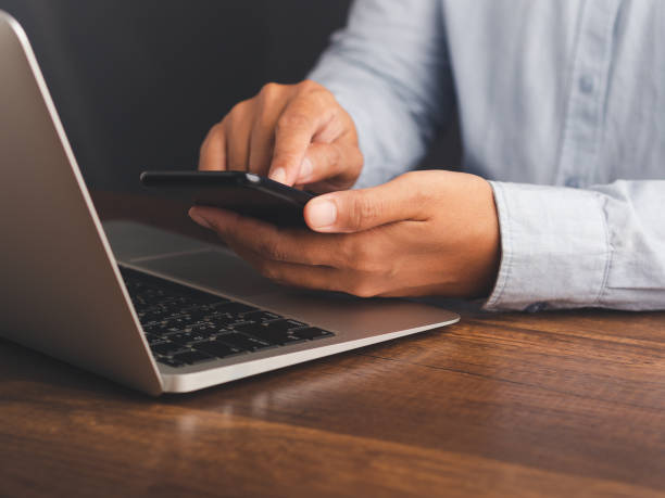 istock Businessman using a smartphone while sitting at a desk in the office. 2156728977