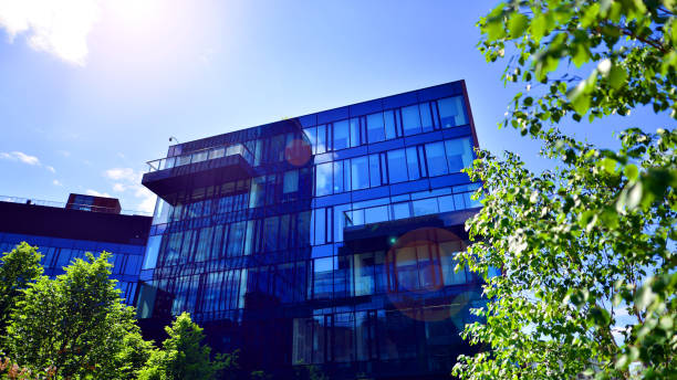 istock Sustainable glass office building with trees for reducing carbon dioxide. 2156729278