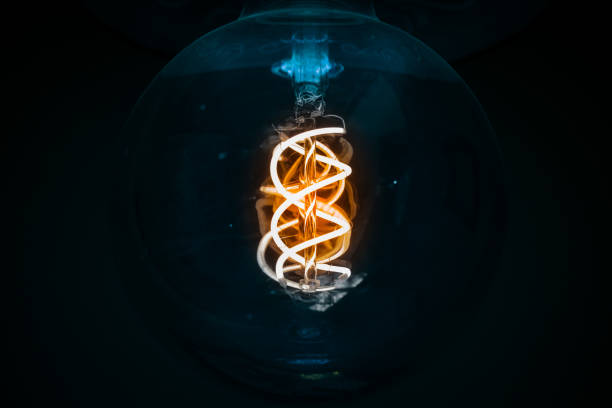 istock light bulb electric lamp spiral element illumination effect soft focus through the glass darkness interior black blue toning background environment space 2156731879