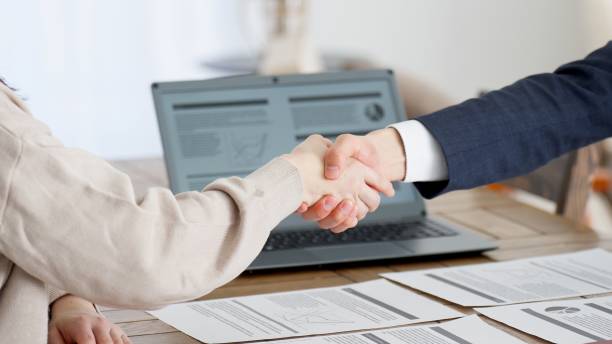 istock Businessmen shaking hands during a sales call 2156732277