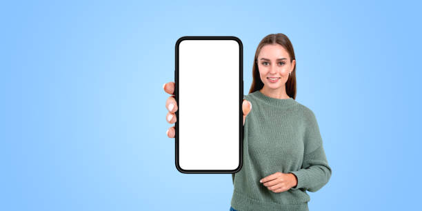 istock Woman hand showing smartphone big mockup screen, empty background 2156734828