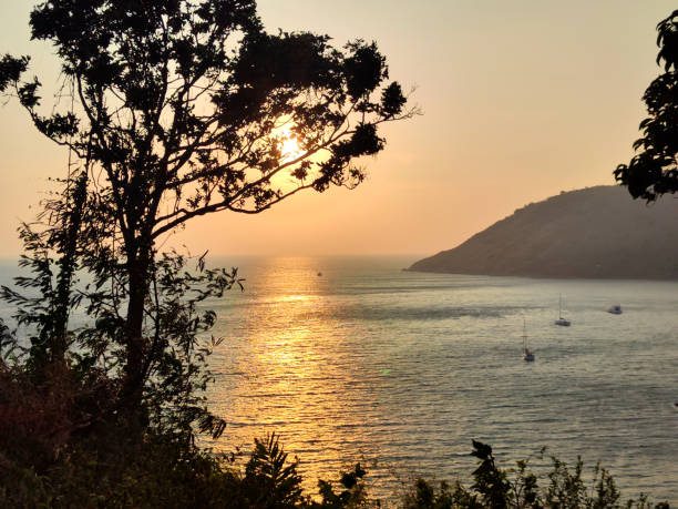 Idyllic sunset at Windmill Viewpoint in the south of Phuket Island, Thailand