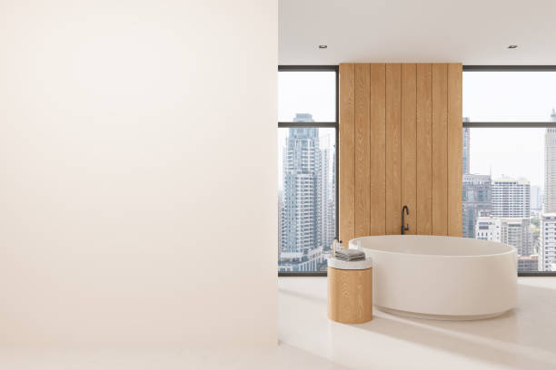 istock Stylish home bathroom interior with tub and panoramic window. Mock up wall 2156735254