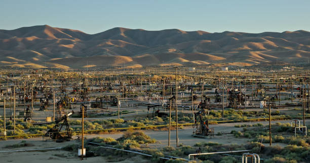 istock Oil Field in Kern County, CA with Hill Range in Background at Sunset 2156736614