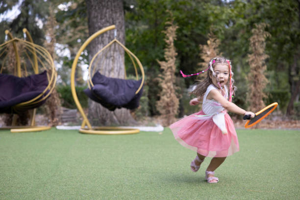 istock Joyful Girl Playing Outdoors in a Park 2156737847