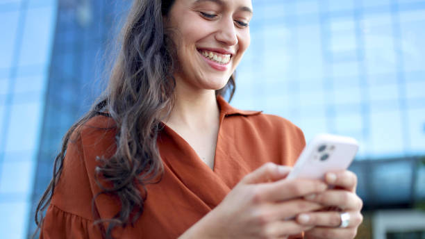 istock Young woman taking a break outdoors and using smartphone 2156741642