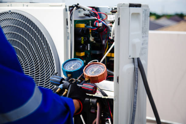 istock Air conditioner service .The air conditioner technician is using a gauge to measure the refrigerant pressure. air compressor. 2156741782