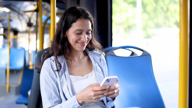 istock Happy girl using smartphone in the bus 2156741815