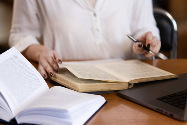 istock Education concept, female student in library, literature 2156742388