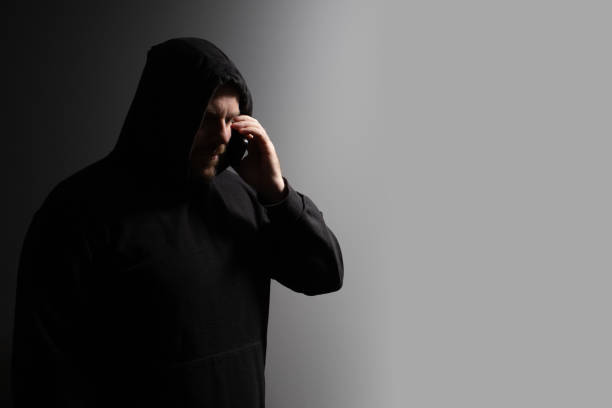 istock Identity thief, a man talking on the phone, behaving like a gangster, risking security breaches, promoting violence. 2156742669