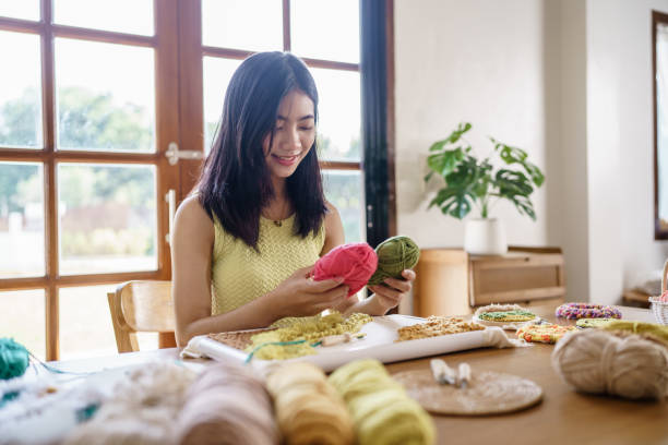 istock Punch needle. Asian Woman making handmade Hobby knitting in studio workshop. designer workplace Handmade craft project DIY embroidery concept. 2156743344
