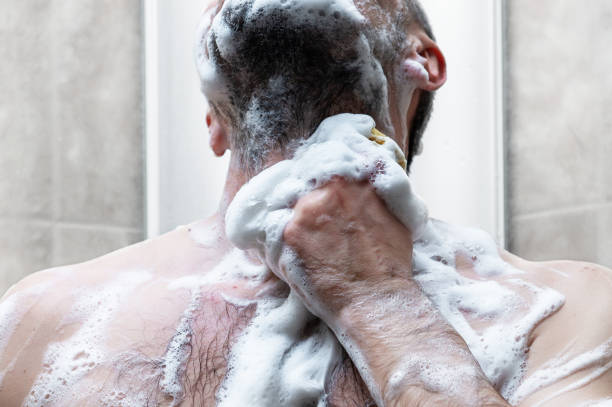 istock man takes a shower in the modern tiled bathroom 2156745727