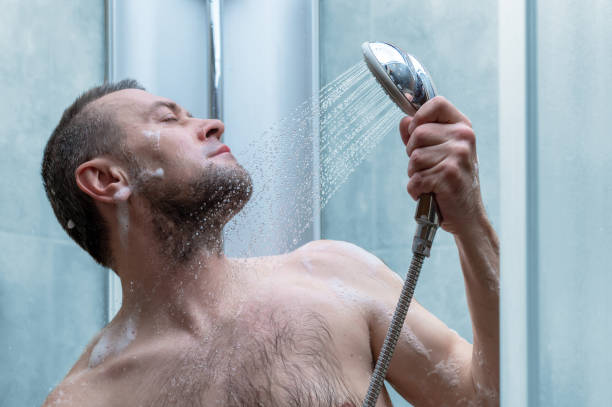 istock man takes a shower in the modern tiled bathroom 2156745765