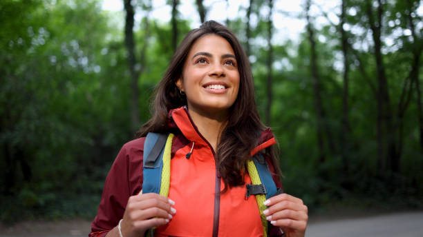 istock Happy girl smiling and enjoying while hiking 2156746353