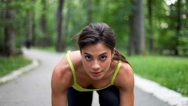 istock Beautiful woman in a low start, ready to run 2156746357