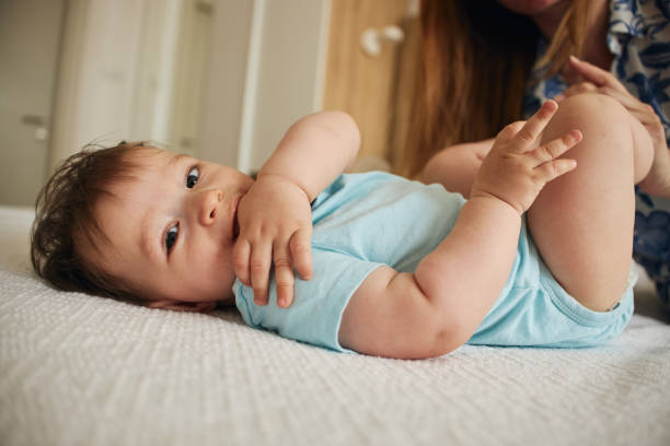 Cheerful baby boy playing with mother