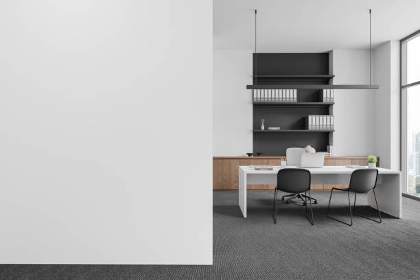 istock Stylish workspace interior with desk and shelf, panoramic window. Mock up wall 2156749590