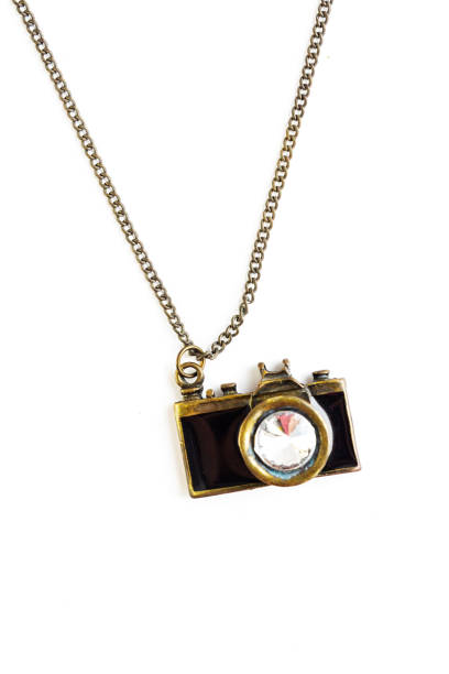 istock Camera pendant with golden chain, isolated on white background. 2156758908