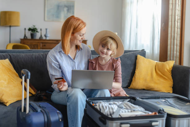 istock Happy mother and daughter making online reservation for a vacation 2156758968