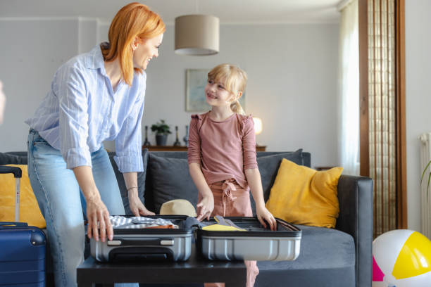 istock Mother and daughter packing for a trip at home 2156758977