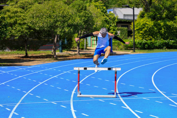 Caucasian professional male athlete jumping over the barrier isolated on white background. Running with obstacles concept. Muscular man. Action, motion, healthy, sport and lifestyle. Copyspace for ad.