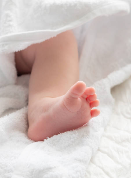 istock Whispers of life: baby's foot tiptoeing out from a towel 2156762204