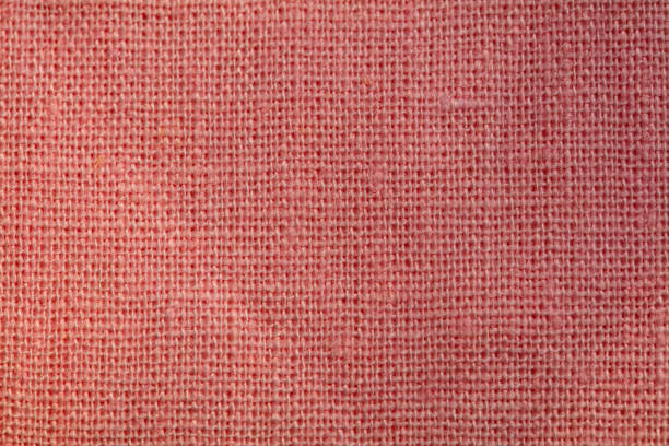 red, burgundy background fabric texture. A piece of woolen cloth is neatly laid out on the surface. Weave and textile texture. Dress fabric or for kitchen needs, tablecloth or curtains, close-up Dash