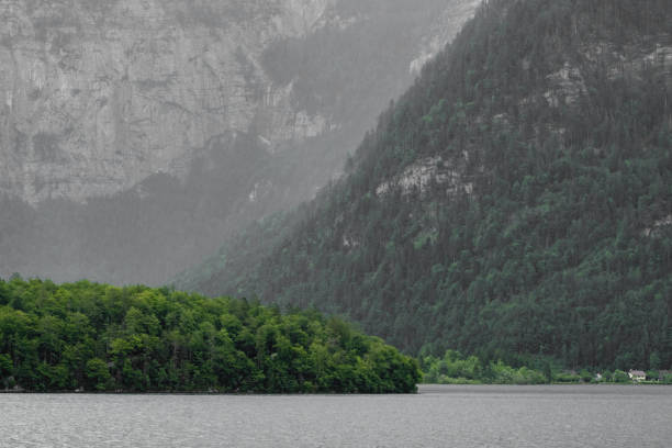 Towering Alpine peaks rise majestically, with lush green valleys below adding to the breathtaking scenery. The rugged mountains create a perfect blend of natural beauty and serenity, inviting exploration and admiration.