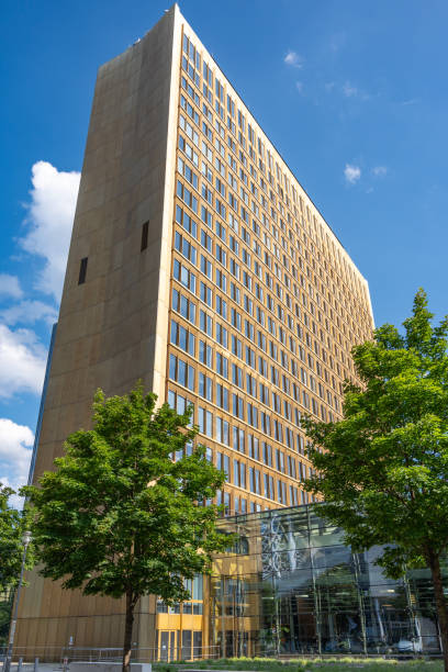 istock A large building with a lot of windows and a tree in front of it 2156771365
